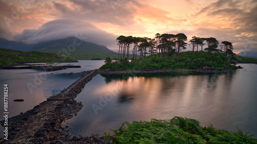 Dramatic Sunrise over Twelve Pines Island on Derryclare Lough in Connemara, County Galway, Ireland, Featuring Misty Mountains and Reflective Water, travel scenic landscape background