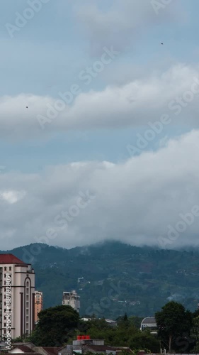 Wallpaper Mural Vertical video - Timelapse of thick clouds engulfing a mountain peak Torontodigital.ca