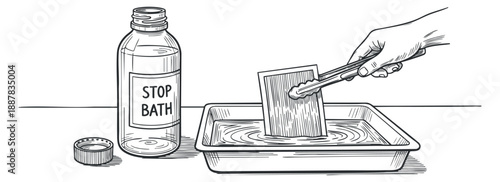 A hand holding a brush while applying stop bath solution in a tray, illustrated in monochrome vector style, ideal for photography process guides