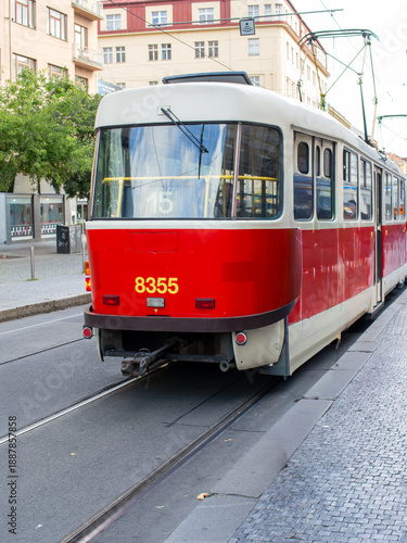 Photography A classic red tram car crossing through a European city center