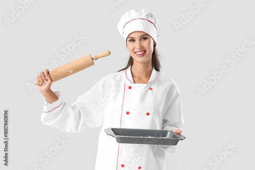 Female chef with baking tra...