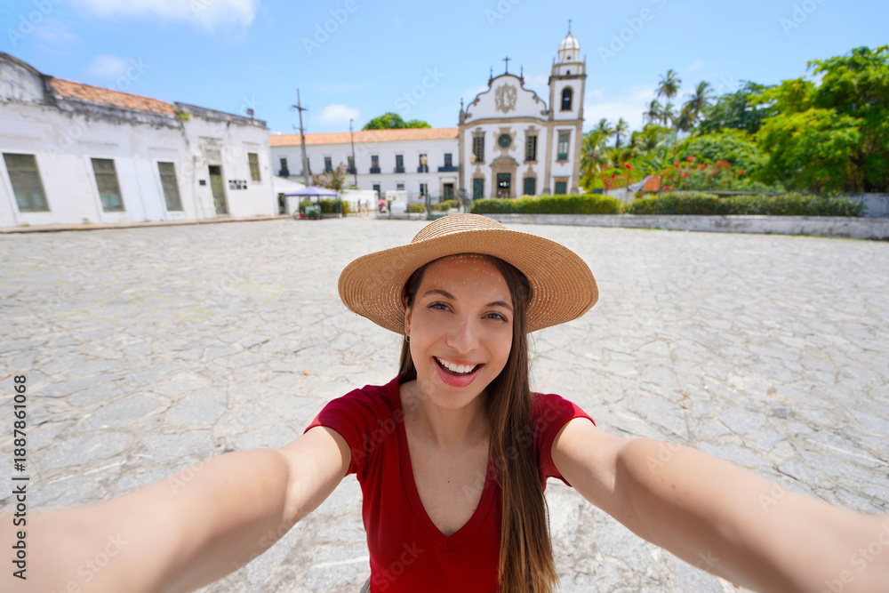 © zigres - Young tourist woman takes selfie with Sao Bento convent in the historic center of Olinda, Pernambuco, Brazil