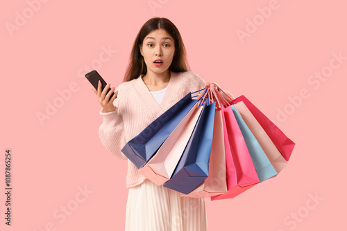 Shocked young Asian woman w...