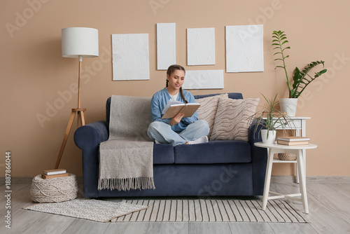 Young woman reading book an...