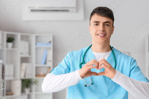 Male doctor making heart ge...
