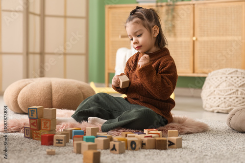 Cute little girl playing wi...