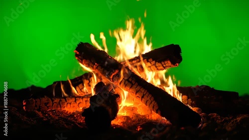 Fiery campfire with glowing embers, against a bright green backdrop