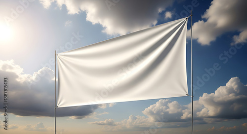 A white flag waving gently in the wind against a blue sky with fluffy clouds and sunlight shining through on a serene day