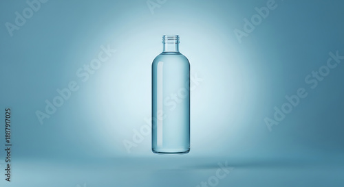 A clear glass bottle with a subtle shadow is centered on a blue surface, illuminated from within, showcasing its transparent contents and sleek design.
