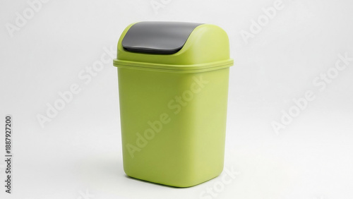 Green plastic trash bin with swing lid isolated on white background
