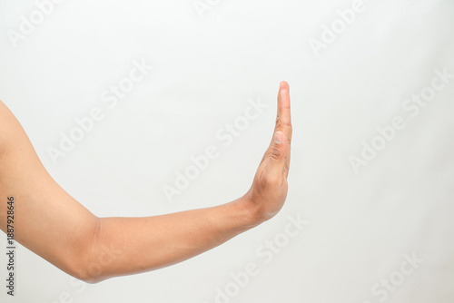Hand gesture stopping or pushing away, human arm against white background