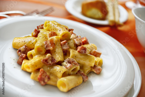 Canvas-taulu Plate with rigatoni carbonara pasta on a laid table