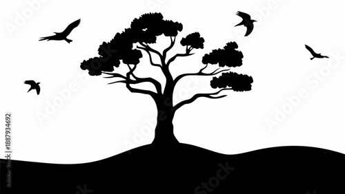 Silhouette of tree with birds flying around it on hill