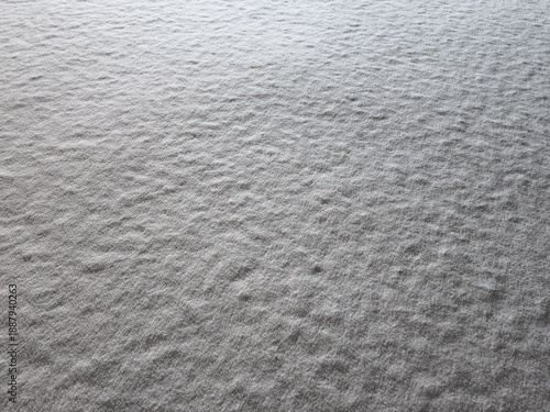 Snowy shadows in evening winter weather, layer of snow