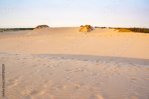 Leba sand desert in Poland at sunset