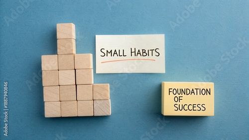Wooden blocks stacked to represent building success and small habits