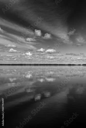 Black and white clouds, river reflection