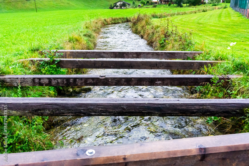 Fototapeta premium Wooden beams over a stream near Lofer, Austria.