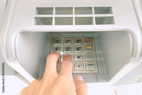 Billede på lærred Close-up of a hand entering a PIN code on an ATM keypad for a financial transact