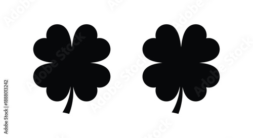 Two dark clover shapes displayed against a white background silhouette