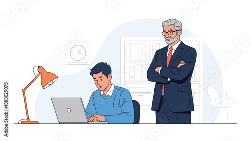 Young employee working on a laptop while an experienced senior manager monitors his progress from behind in the office.