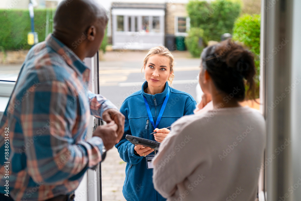 Obraz premium People talking at the door during the day in a city area with a woman holding a clipboard
