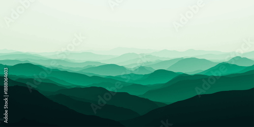 A misty mountain landscape at dawn featuring a blue sky and rolling hills covered in morning fog and clouds over a vast valley panorama