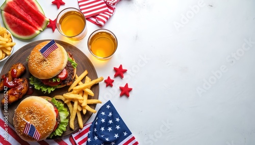 Burgers wings and fries served on table with American flags and drinks. Celebrate Independence Day with festive July fourth picnic food. Enjoy watermelon and beer.
