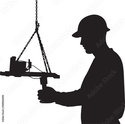 Silhouette of a worker operating a crane attachment