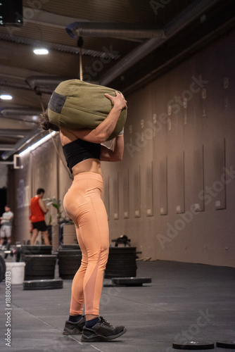 Woman Adjusting Stance For Deadlift Precision, Female Athlete Carefully Setting Up For Powerful Deadlift Execution, Woman Meticulously Aligning Her Body And Equipment For Optimal Deadlift Performance