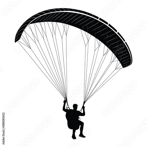 A silhouetted paraglider soars through the air showcasing human flight