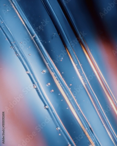 Close-Up of Glowing Blue Gel Streaks on Glass Surface