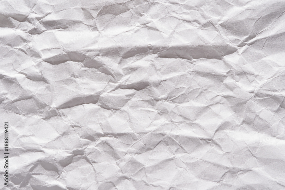 Fototapeta premium Textured white wrinkled paper close-up background for creative design and art projects.