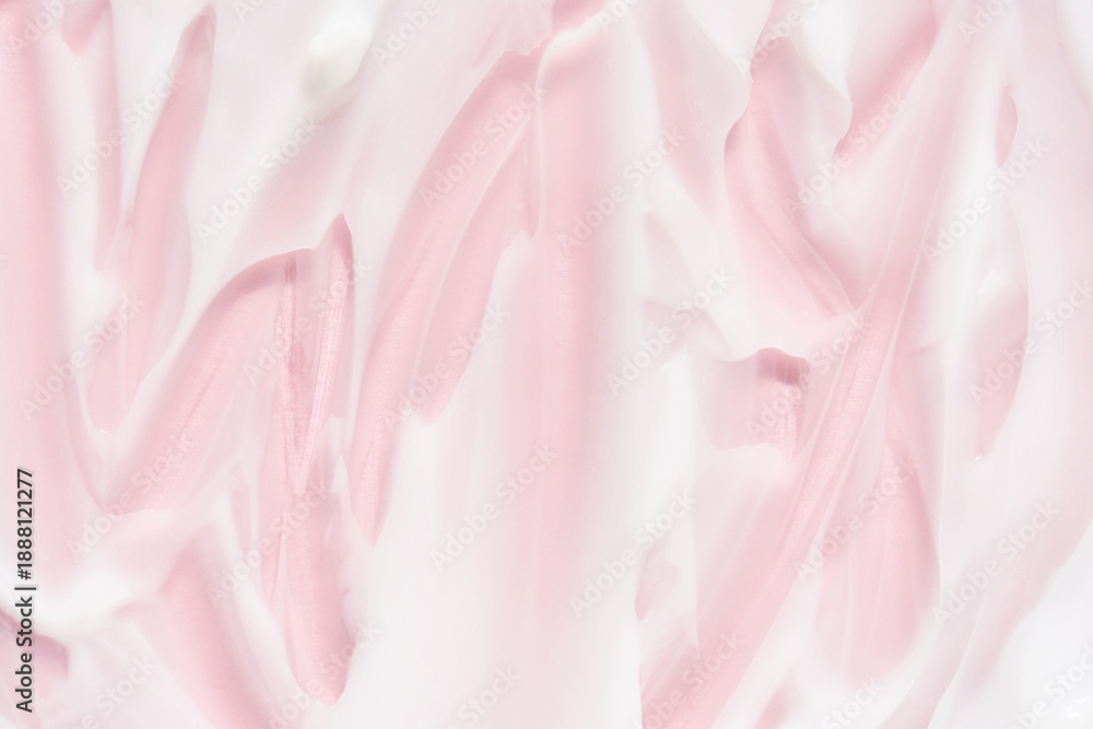 Obraz premium Smooth pink and white cream or lotion texture with soft swirls and brushstrokes for skincare or cosmetic product background.