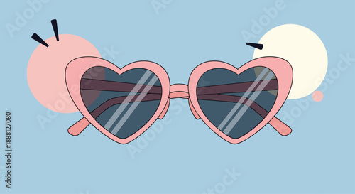 Stylish heart shaped sunglasses in pink with dark lenses against a light blue sky with abstract pastel shapes.