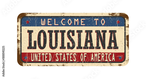 Welcome to Louisiana. An old worn sign with an inscription. Welcome metal plaque with rust elements