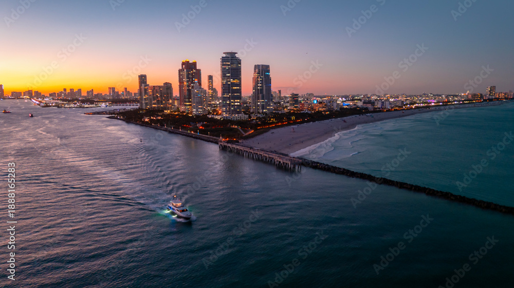 Naklejka premium Miami Beach city night aerial view. Miami night coastal cityscape. Miami shoreline. Aerial view of Miami Beach at night.