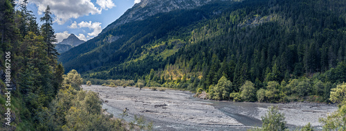 Pristine nature in the Tiroler Lech Nature Park and Natura 2000 protected area, Tyrol, Austria. Forested mountain slopes and wild river landscapes offering untouched tranquility and scenic wilderness.