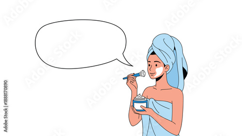 Relaxed young woman with a towel on her head applying a moisturizing face cream with a brush as part of her morning beauty routine.