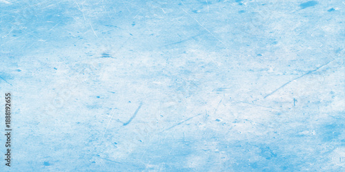 A blue grunge abstract texture background featuring a frozen winter frost pattern with white snow and cold ice on a weathered nature surface under a light sky