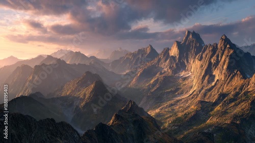 4K Breathtaking mountain range landscape at golden hour with dramatic clouds and rugged peaks bathed in warm light video