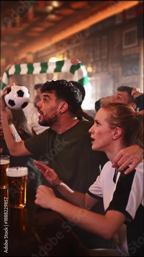 Excited soccer fans celebrating a goal in a sports bar