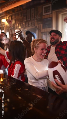 Excited american football fans celebrating victory in a sports bar