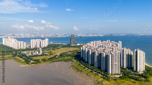 Aerial panoramic view of Forest City, an artificial island, built in Johor Bahru, Malaysia, Singapore can be seen at the distance as background.