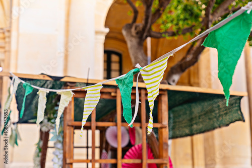 Wallpaper Mural Green fabric bunting over street market stall in warm light Torontodigital.ca