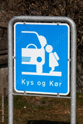 Kiss and drive area road sign in front of a school in Denmark