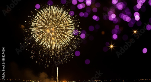 Golden firework burst in night sky with purple bokeh