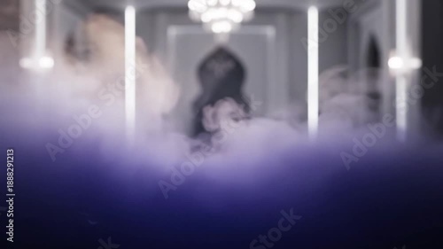 Woman surrounded by fog in a luxurious interior with chandeliers.