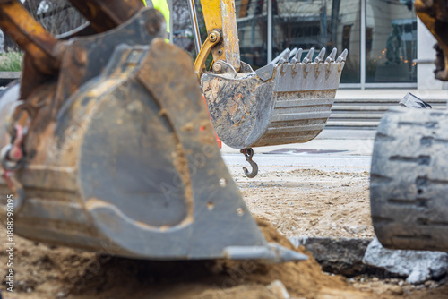 Earth mover shovels move dirt around large Atlanta sink hole