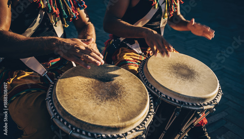 People playing drums in a park. Scene is lively and energetic.